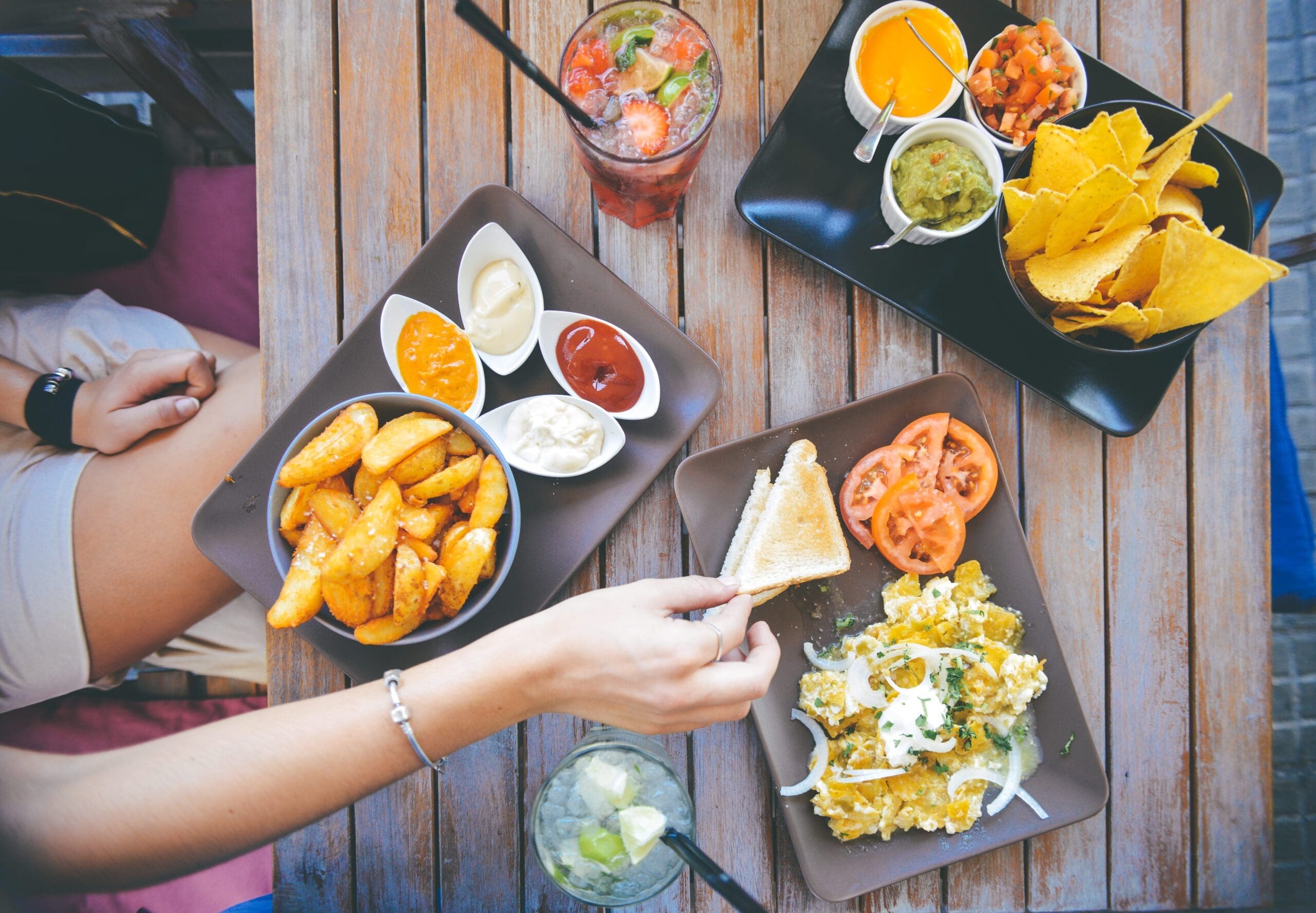 Young professional dips chip during her lunch break